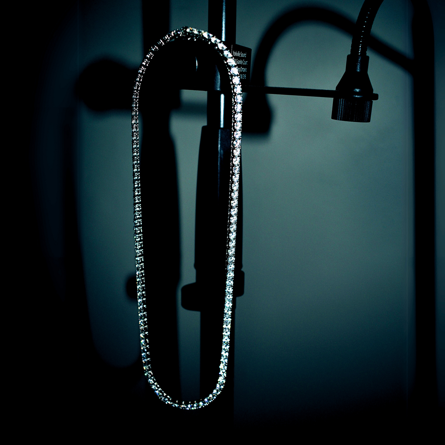 Iced out Moissanite tennis chain necklace showcasing VVS clarity stones against a dark background.